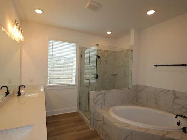 8518 Pier Cove Dr, Cypress, TX 77433 - bathroom with a bath, a marble finish shower, double vanity, wood finished floors, and recessed lighting