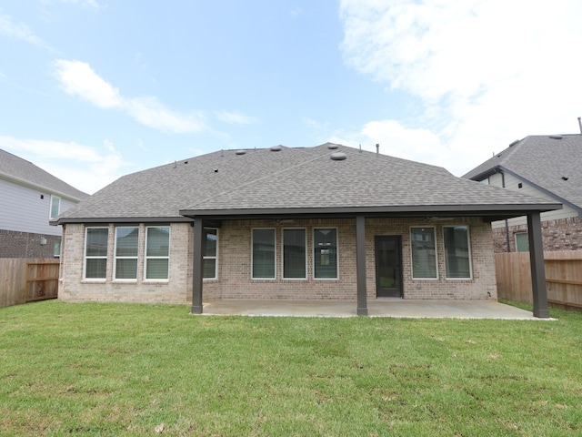 8518 Pier Cove Dr, Cypress, TX 77433 - rear view of house featuring a shingled roof, a patio area, a fenced backyard, and brick siding