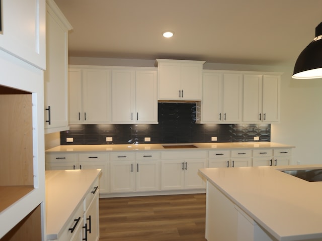 8518 Pier Cove Dr, Cypress, TX 77433 - kitchen featuring wood finished floors, decorative backsplash, white cabinets, and recessed lighting