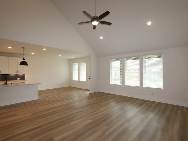 8518 Pier Cove Dr, Cypress, TX 77433 - unfurnished living room featuring recessed lighting, a ceiling fan, wood finished floors, and high vaulted ceiling