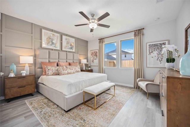 bedroom with baseboards, ceiling fan, and wood finished floors