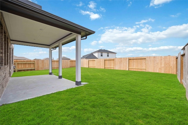 view of yard featuring a patio area and a fenced backyard