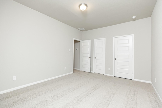 unfurnished bedroom with baseboards and carpet floors