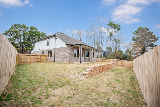 view of yard with a fenced backyard