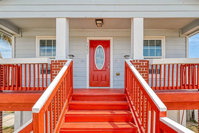 view of exterior entry with covered porch