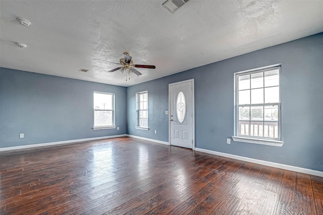 entrance foyer featuring a ceiling fan, wood finished floors, visible vents, baseboards, and a textured ceiling