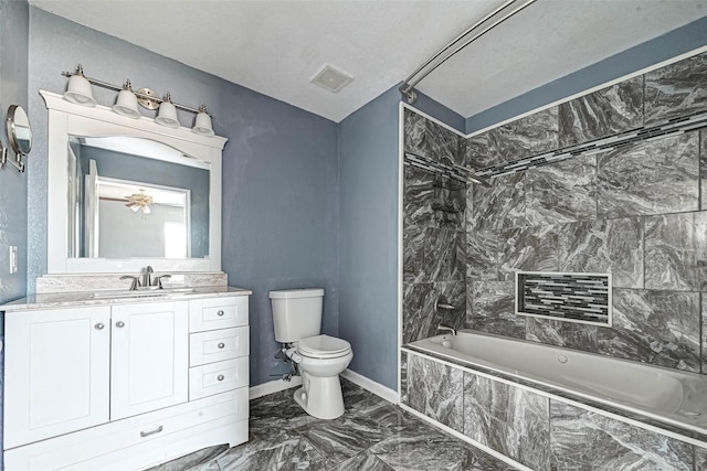 bathroom with visible vents, toilet, tiled shower / bath combo, marble finish floor, and vanity