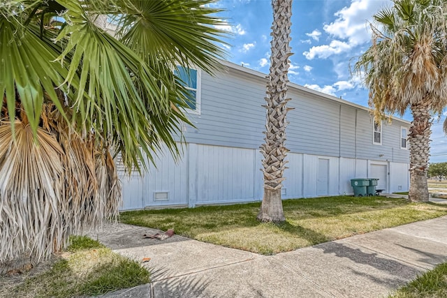 view of property exterior with a yard