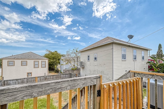 exterior space with cooling unit and fence