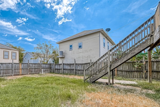 exterior space with a lawn and a fenced backyard