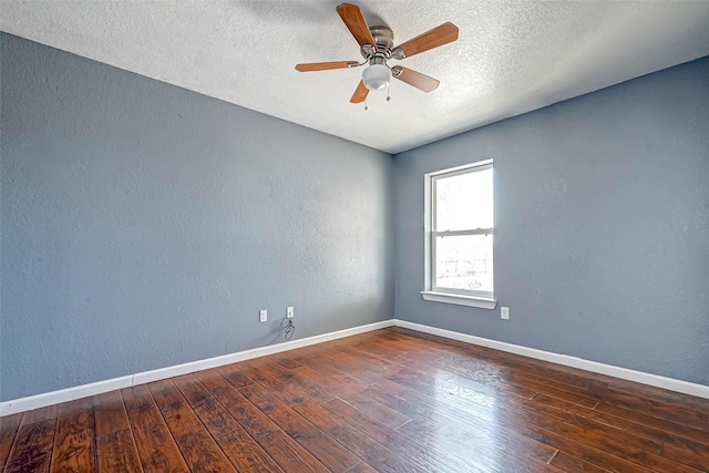 unfurnished room featuring a textured wall, a textured ceiling, baseboards, and hardwood / wood-style flooring