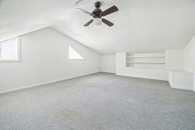 additional living space with built in features, baseboards, and carpet flooring