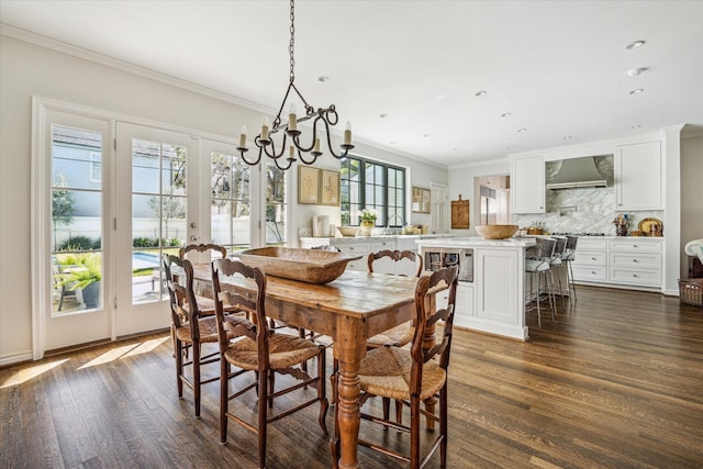 dining area with recessed lighting, french doors, dark wood finished floors, and crown molding