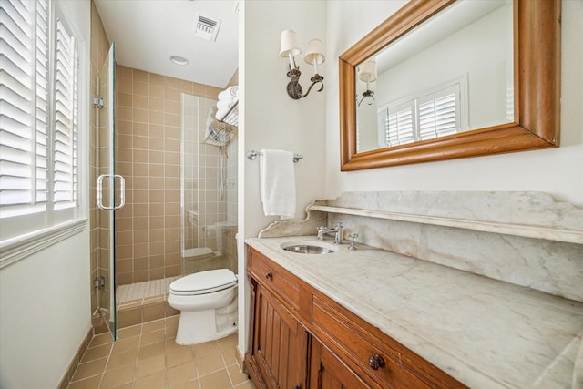 bathroom with a shower stall, toilet, a healthy amount of sunlight, and visible vents