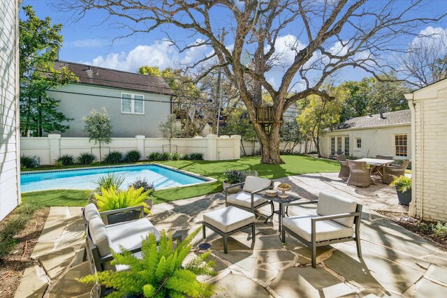 view of patio / terrace featuring an outdoor living space, a fenced in pool, and a fenced backyard