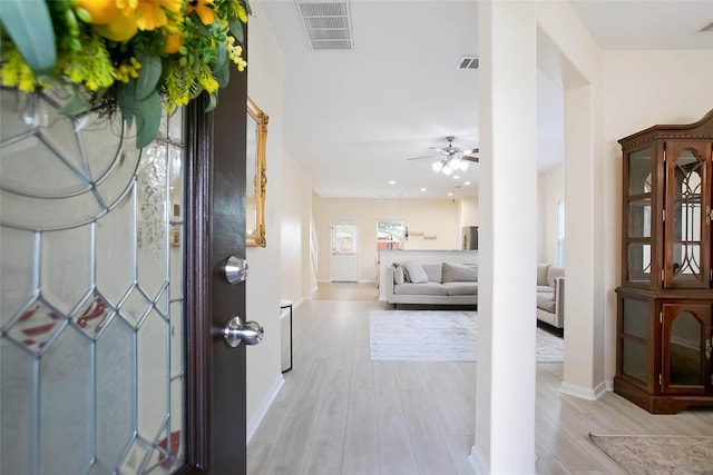 4918 Seaside Sparrow Ln, Baytown, TX 77521 - foyer entrance featuring visible vents, baseboards, light wood-style floors, and a ceiling fan