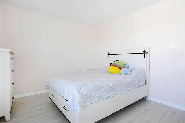 4918 Seaside Sparrow Ln, Baytown, TX 77521 - bedroom with baseboards and light wood-style floors