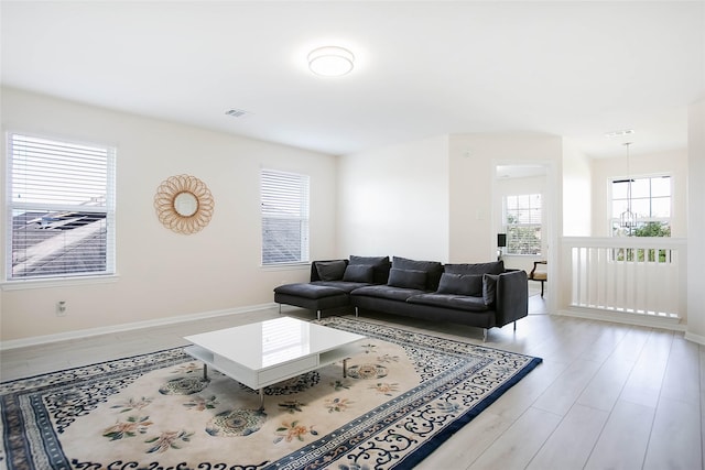 4918 Seaside Sparrow Ln, Baytown, TX 77521 - living room featuring visible vents, baseboards, and wood finished floors