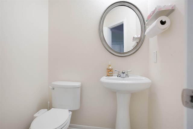 4918 Seaside Sparrow Ln, Baytown, TX 77521 - bathroom with a sink, baseboards, and toilet