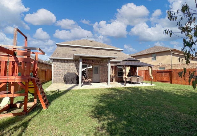 4918 Seaside Sparrow Ln, Baytown, TX 77521 - back of house with a fenced backyard, a lawn, a playground, a patio area, and brick siding