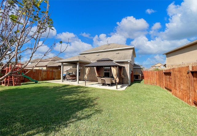 4918 Seaside Sparrow Ln, Baytown, TX 77521 - back of property featuring a fenced backyard, a gazebo, a playground, a patio area, and brick siding