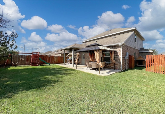 4918 Seaside Sparrow Ln, Baytown, TX 77521 - rear view of property with a fenced backyard, a playground, a gazebo, brick siding, and a patio area