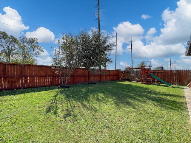 4918 Seaside Sparrow Ln, Baytown, TX 77521 - view of yard featuring a fenced backyard and a playground
