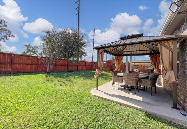 4918 Seaside Sparrow Ln, Baytown, TX 77521 - view of yard featuring outdoor dining space, a gazebo, a patio area, and a fenced backyard