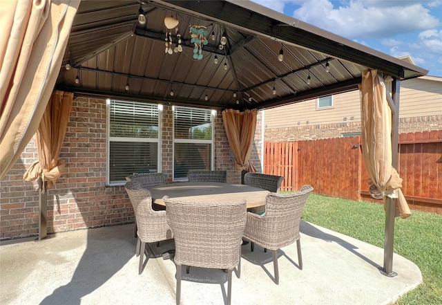 4918 Seaside Sparrow Ln, Baytown, TX 77521 - view of patio featuring a gazebo, outdoor dining area, and fence