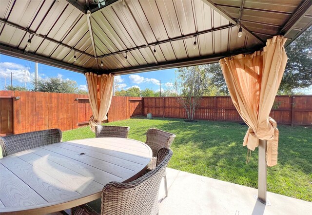 4918 Seaside Sparrow Ln, Baytown, TX 77521 - view of patio featuring a gazebo, outdoor dining area, and a fenced backyard
