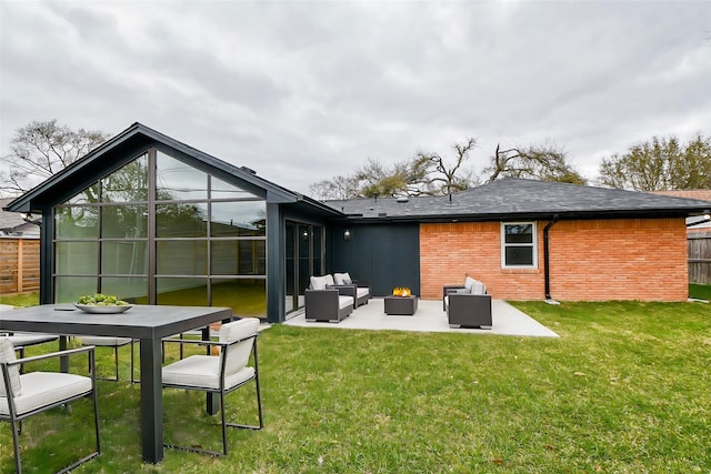 rear view of property with brick siding, fence, a lawn, outdoor lounge area, and a patio area