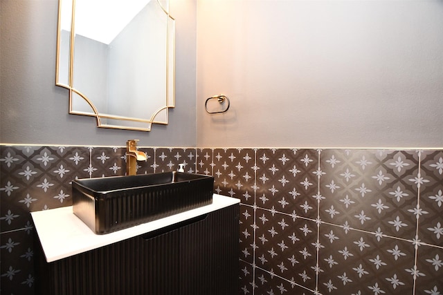 bathroom featuring a wainscoted wall and a sink