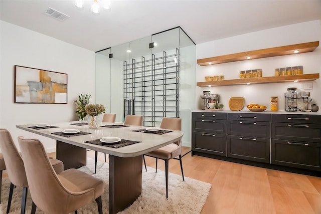 dining room with visible vents and light wood-type flooring