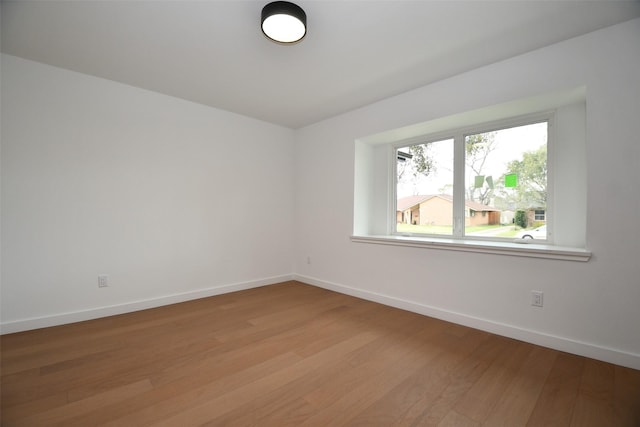 spare room with light wood-style flooring and baseboards