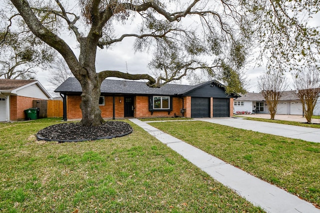 view of front of home with fence, concrete driveway, a front yard, an attached garage, and brick siding