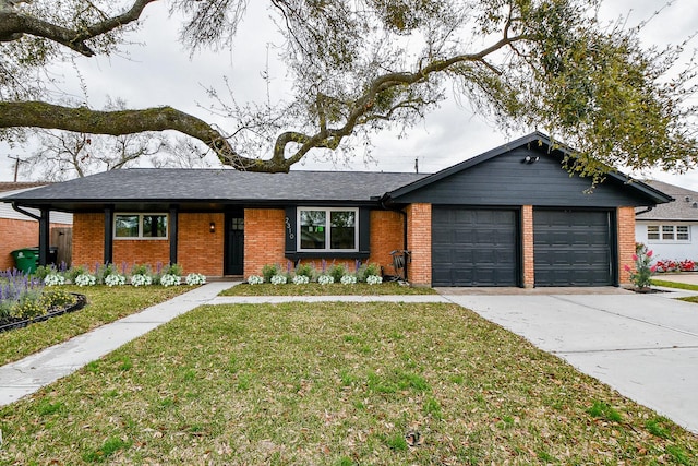 ranch-style home with driveway, a shingled roof, an attached garage, a front yard, and brick siding