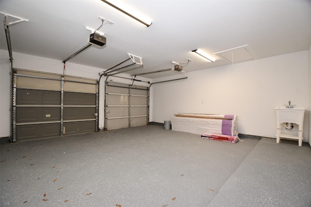 garage with a sink and a garage door opener