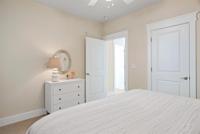 bedroom with ceiling fan, baseboards, and carpet floors