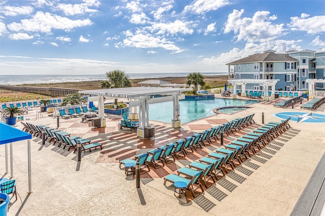 pool with a patio, a community hot tub, and a pergola