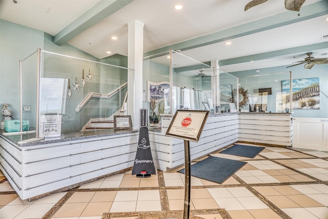 reception featuring ornate columns, stairway, visible vents, and ceiling fan