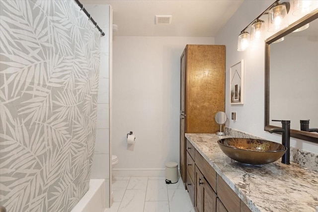 bathroom featuring vanity, baseboards, visible vents, toilet, and marble finish floor