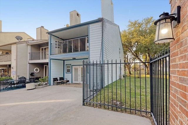 exterior space with a lawn and fence