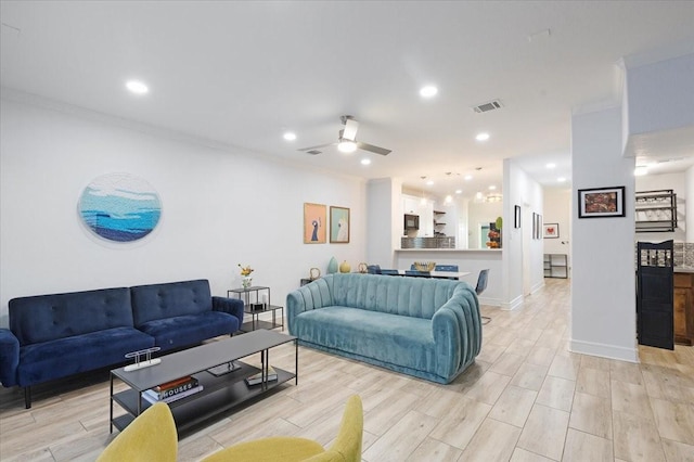 living room featuring visible vents, recessed lighting, a ceiling fan, and ornamental molding