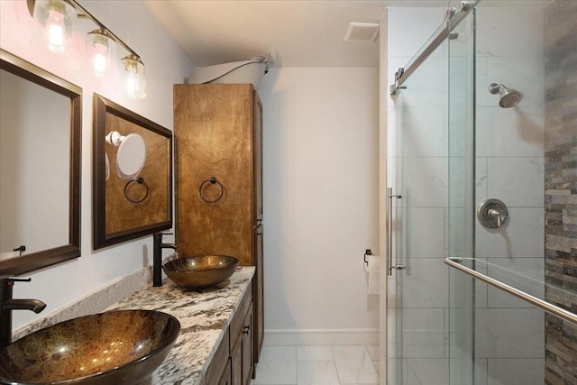 full bath with a shower stall, visible vents, marble finish floor, and a sink