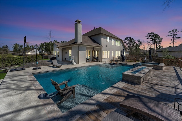 view of swimming pool featuring a fenced in pool, a patio, an in ground hot tub, and fence