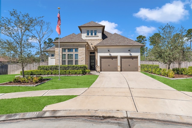 prairie-style house featuring fence, stucco siding, driveway, stone siding, and an attached garage