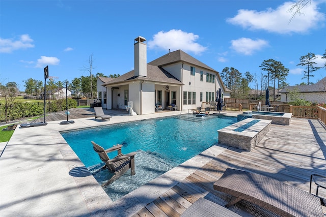 view of pool with a fenced in pool, an in ground hot tub, a fenced backyard, and a patio