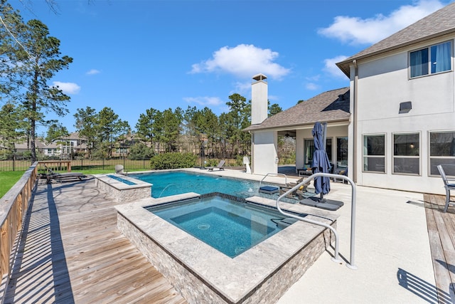 view of pool with a fenced in pool, a wooden deck, a fenced backyard, an in ground hot tub, and a patio