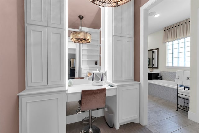 office space featuring light tile patterned flooring and built in study area