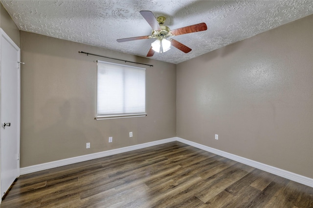 empty room with baseboards, a textured ceiling, and wood finished floors